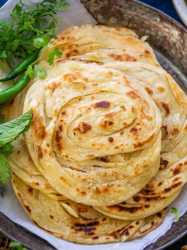 Kerala Parotta or Malabar Parotta is a layered Indian flatbread which goes great with curries. Here is how to make it in a traditional way.
