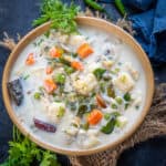 Vegetable Stew is a Kerala Style veg curry where veggies are cooked in coconut milk and very mild spices. It goes great with appam and rice. Here is how to make it.