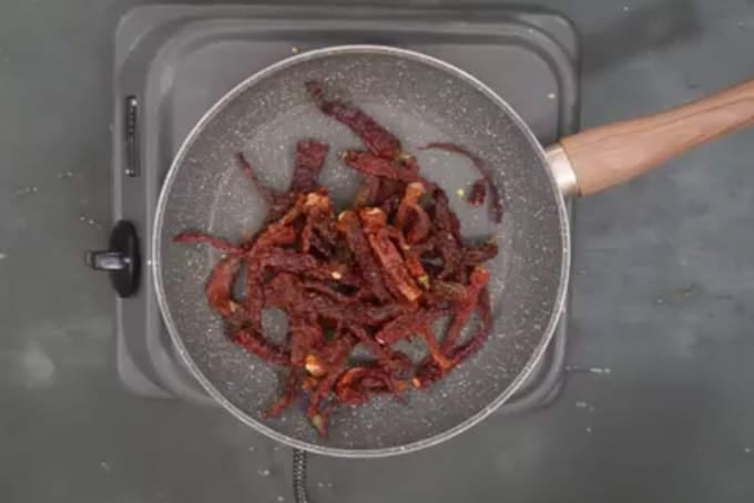 Chillies roasting in a pan.