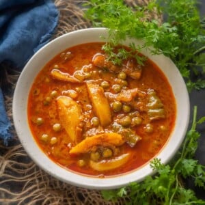 Made using potato cubes and green peas simmered in an onion tomato gravy, Aloo Matar Curry is a simple, delicious Indian main course dish that vouches for a wholesome, healthy meal for your family. This vegan and the gluten-free dish is perfect to serve with any Indian bread.