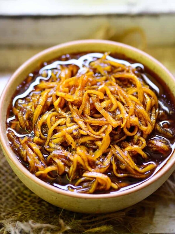 Aam chunda is a Gujarati-style spicy, sweet and sour mango pickle made using green raw mangoes. This vegan and gluten-free pickle is a perfect accompaniment to your summer Indian meals. Here is how to make it.