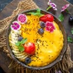 Start your day with this sweet tropical mango smoothie bowl which comes together in under 15 minutes. It's hearty and filling and can be made vegan and gluten-free.