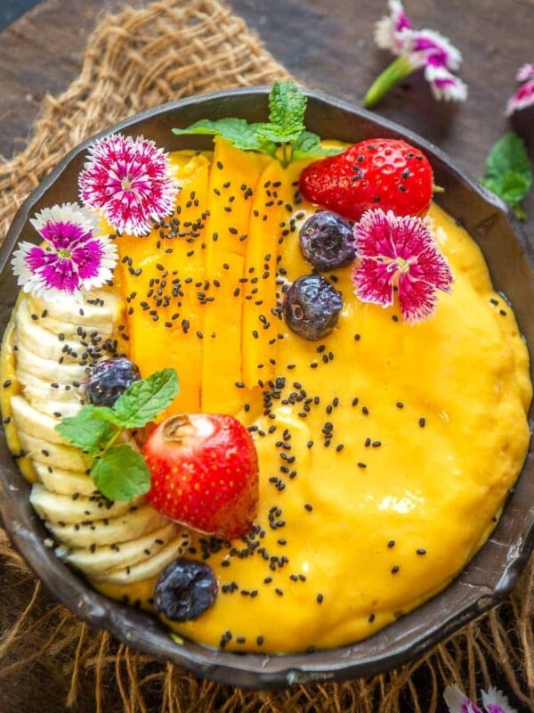 Start your day with this sweet tropical mango smoothie bowl which comes together in under 15 minutes. It's hearty and filling and can be made vegan and gluten-free.