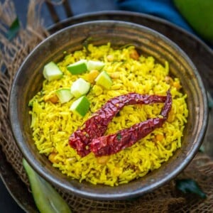 Raw Mango Rice, Mavinakayi Chitranna, or Mamidikaya Pulihora is South Indian green mango-flavored rice. This variety of rice is a lovely variation of the popular lemon rice but with a tang from green mangoes. Here is how to make it.