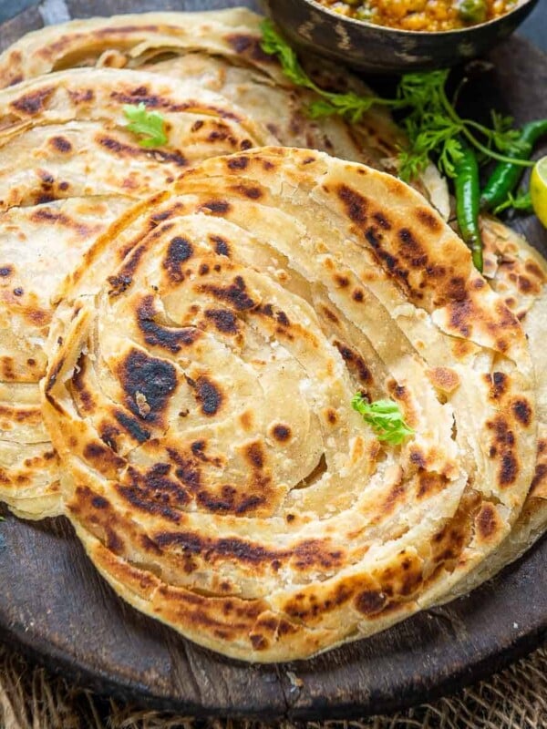 Lachha Paratha (Lachedar Paratha) is a popular layered Indian flatbread made using whole wheat flour. It is very flaky and crispy and pairs very well with Indian curries. Check out 3 ways to make it at home (vegan).