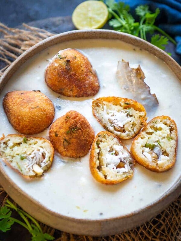 Malai kofta is a delicious Indian curry made by dunking deep-fried potato and paneer balls (kofta) in a rich velvety smooth gravy. Make perfect restaurant-style malai kofta using my tried and tested recipe. 2 styles of gravy included in the post.