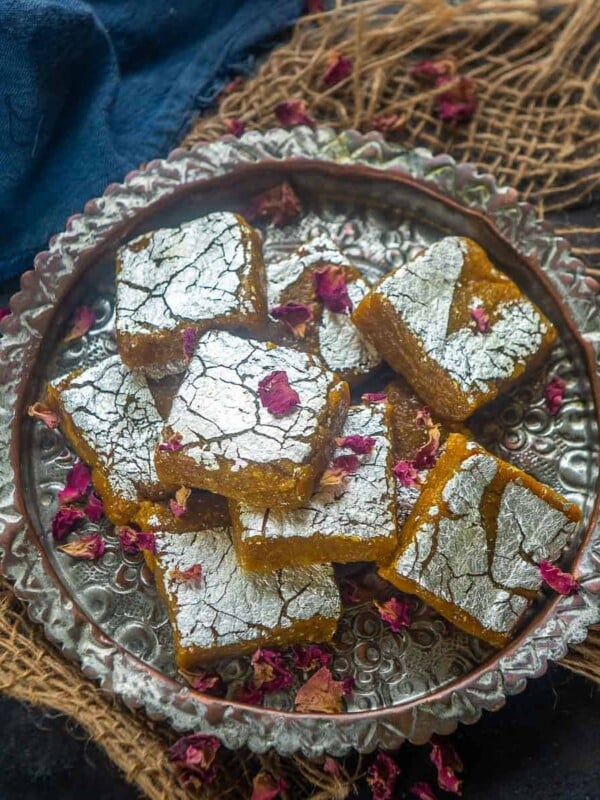 This mango burfi will be your new favorite Indian mithai this summer season. It is a delicious combination of fresh mangoes, milk powder, coconut, and dry fruits. Here is how to make it.