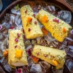 Mango Kulfi is an Indian-style ice cream flavored with mango puree. Make it using fresh mangoes in the summers or frozen mangoes or canned mango puree throughout the year.