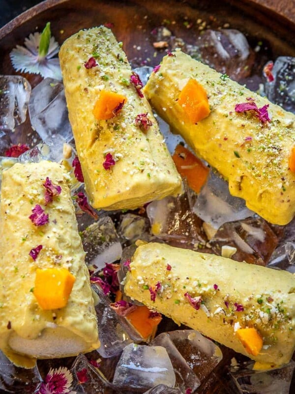 Mango Kulfi is an Indian-style ice cream flavored with mango puree. Make it using fresh mangoes in the summers or frozen mangoes or canned mango puree throughout the year.