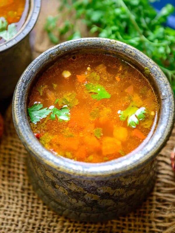 Tomato Rasam is a spicy and tangy South Indian-style soup made using tomatoes, tamarind, and a spice mix called rasam powder. It is a staple in most South Indian households and is served with steamed rice for everyday meals. Make it using my easy recipe.