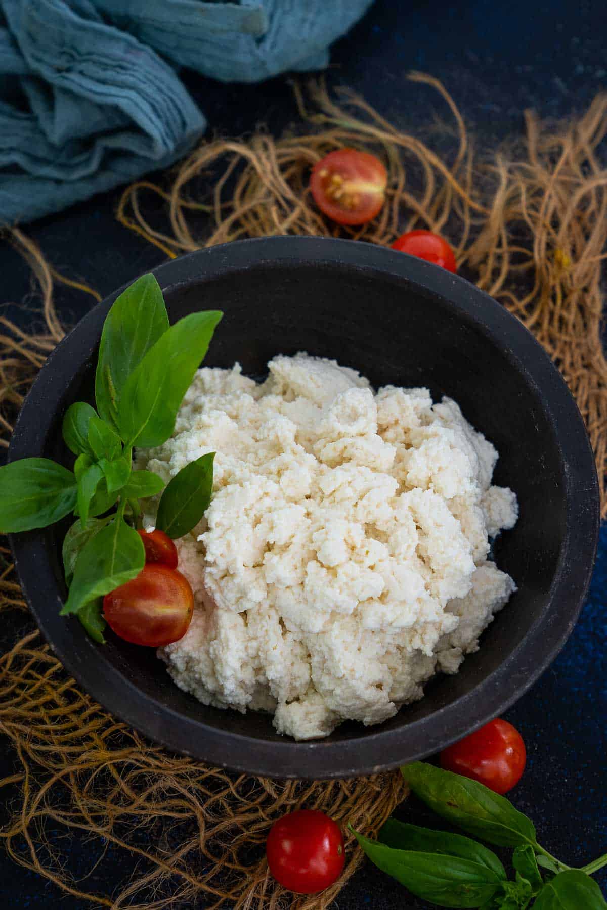 Homemade ricotta cheese served in a bowl.