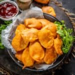 Aloo Pakora (Potato Bajji) is a very popular Indian snack where thinly sliced potatoes are coated with a spiced chickpea flour batter and deep-fried until crispy. This 20-minute snack is best enjoyed with green chutney and masala chai on the side (vegan, gluten-free).