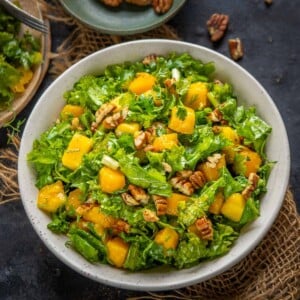 This healthy kale mango salad is a must-make recipe while mangoes are in season. It's easy to make, comes together in 5 minutes, can be made vegan, and makes for a great light side dish, lunch or dinner.
