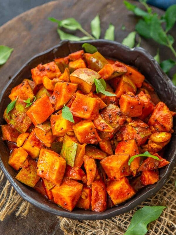 This Kerala-Style Instant Mango Pickle (Nurukka Manga Achar) is a tangy recipe made using raw mangoes and spices. It comes together in 45 minutes (including rest time) and is a must-have item on onam sadya. Here is how to make it (vegan).