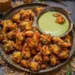 Moong Dal Pakoda (Moong Dal Bhajia, Moong Dal Vada, Moongode) are Indian lentil fritters made using yellow moong dal and a few other simple ingredients. Serve them with green chutney for tea time snack (vegan, gluten-free).