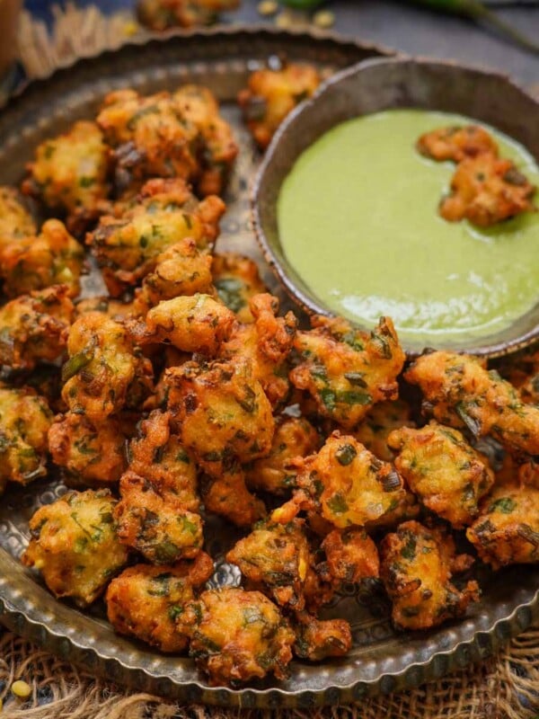 Moong Dal Pakoda (Moong Dal Bhajia, Moong Dal Vada, Moongode) are Indian lentil fritters made using yellow moong dal and a few other simple ingredients. Serve them with green chutney for tea time snack (vegan, gluten-free).