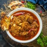 Mutton rara curry served in a bowl.