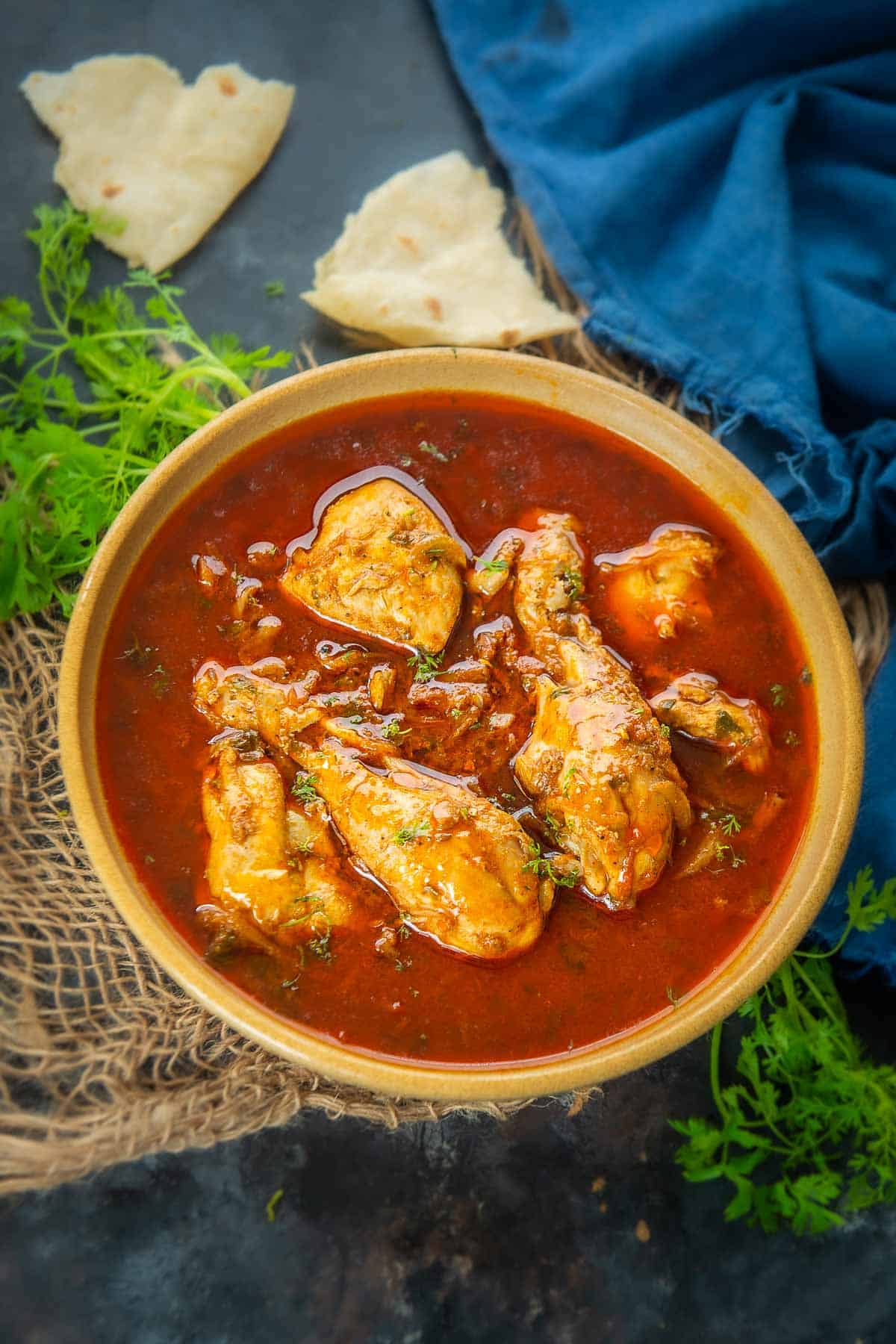 Tomato chicken curry served in a bowl.