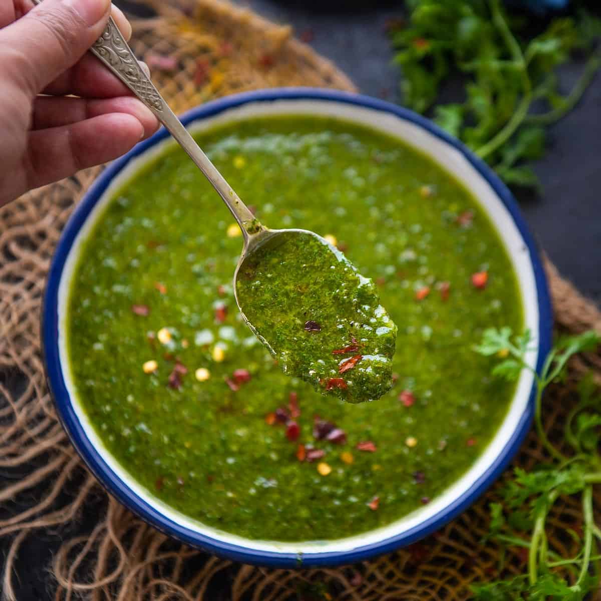 A closeup of cilantro chimichurri sauce in a jar