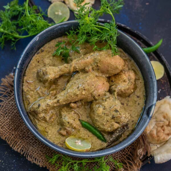 Coriander Chicken Curry (Dhaniya Chicken Curry) is a delicious North Indian style curry made using chicken pieces, cilantro, mint, dried nuts, and a few spices. Use my easy recipe to make it.