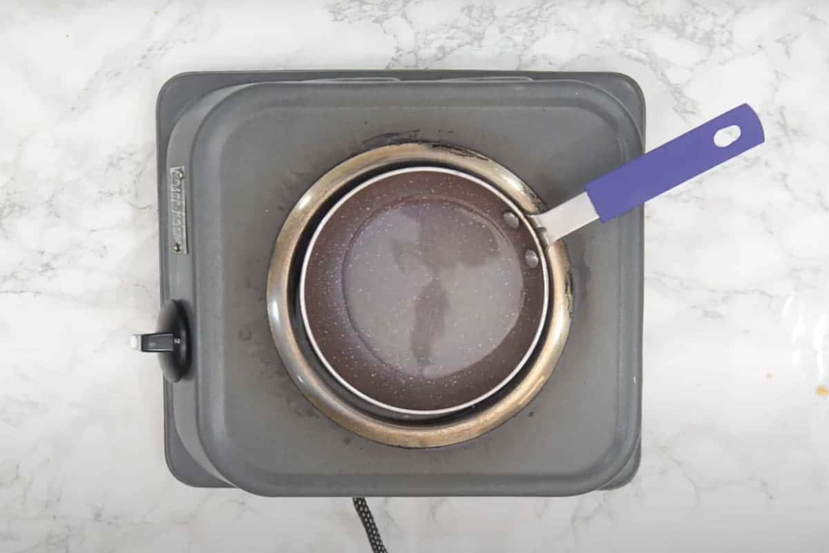 Coconut oil heating in a pan.