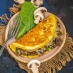 Mushroom Omelette with Spinach & Cheese is a delicious and healthy breakfast option which is super easy to make as well. Make it for a quick breakfast using my easy recipe (gluten-free).