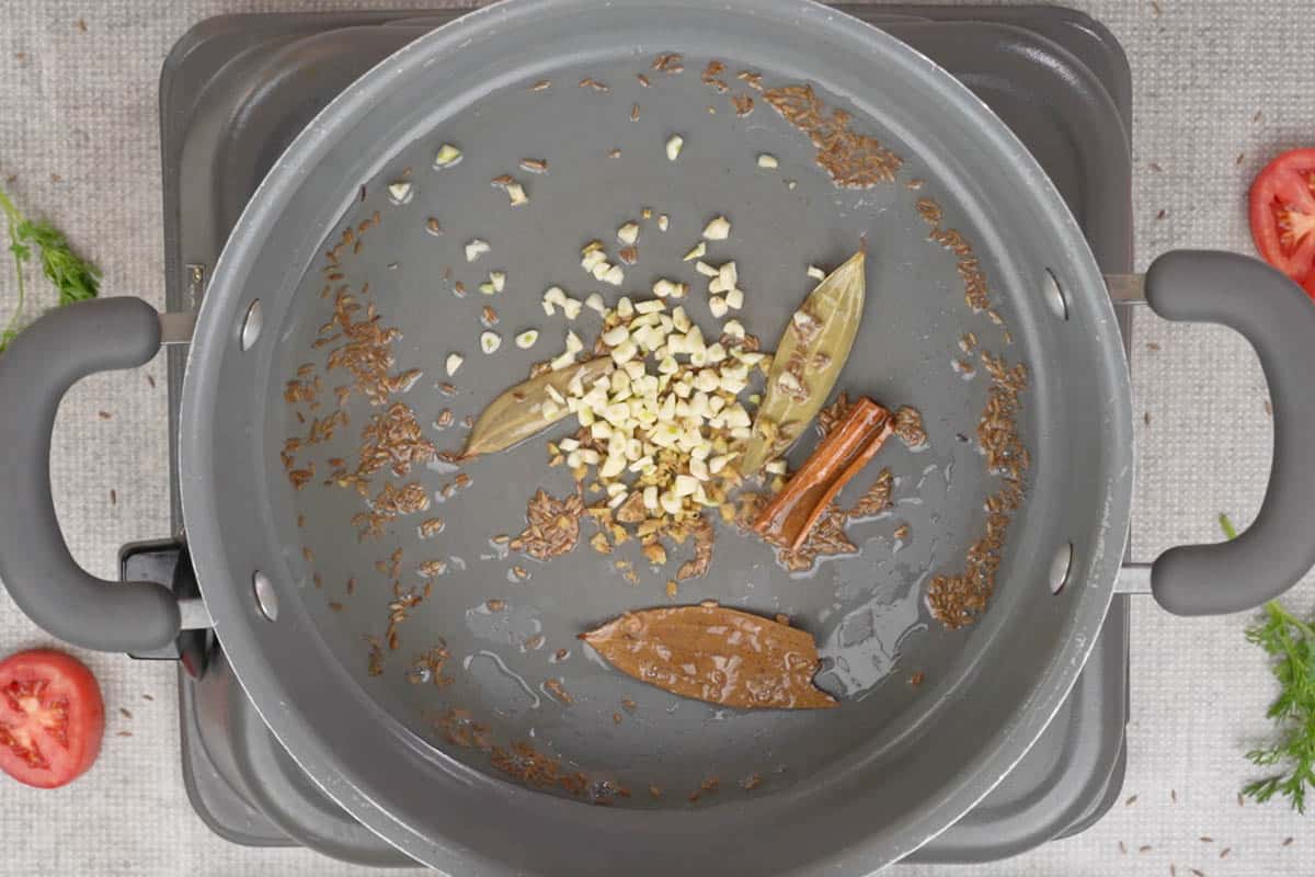 Ginger and garlic added to the pan.