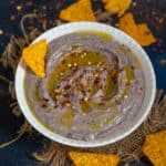 This creamy Black Bean Hummus is a delicious take on classic hummus where black beans are used instead of chickpeas. This vegan and gluten-free dip is a party favorite and can be served with tortilla chips, veggie sticks, or pita bread.