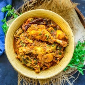 Bold, spicy, and full of flavors, Chicken Masala is a delicious Indian Chicken Curry, where marinated chicken is cooked in tomato-onion gravy. Serve it with Chapati and Kachumber Salad for a hearty meal. Here is how to make it.