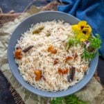 Ghee Rice (Nei Choru, Neychoru) is a Kerala style rice dish where rice is cooked with lots of ghee and spices. This dish is perfect to serve as a side dish with your everyday meals. Here is how to make it.
