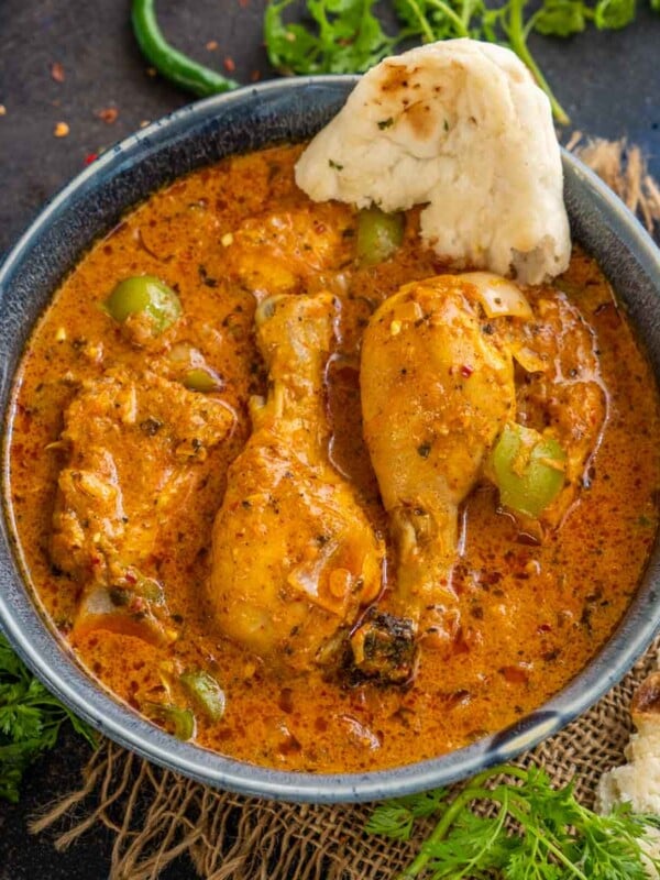Kadai Chicken (Chicken Karahi Curry) is a delicious Indian chicken curry where chicken is cooked with freshly ground spices. This spicy curry goes well with naan or any other Indian bread.