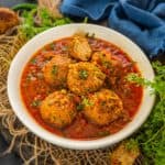 Lauki Kofta Curry is a delicious Indian curry where bottle gourd dumplings are simmered in an onion-tomato base curry. Make it using my easy recipe (vegan, gluten-free).