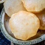 Poori (Puri) is an Indian fried puffed bread made with whole wheat flour. This unleavened bread is soft, fluffy, and crispy and is perfect to serve with Indian curries. Check out my easy recipe to make perfectly puffed-up non-oily poori every time.