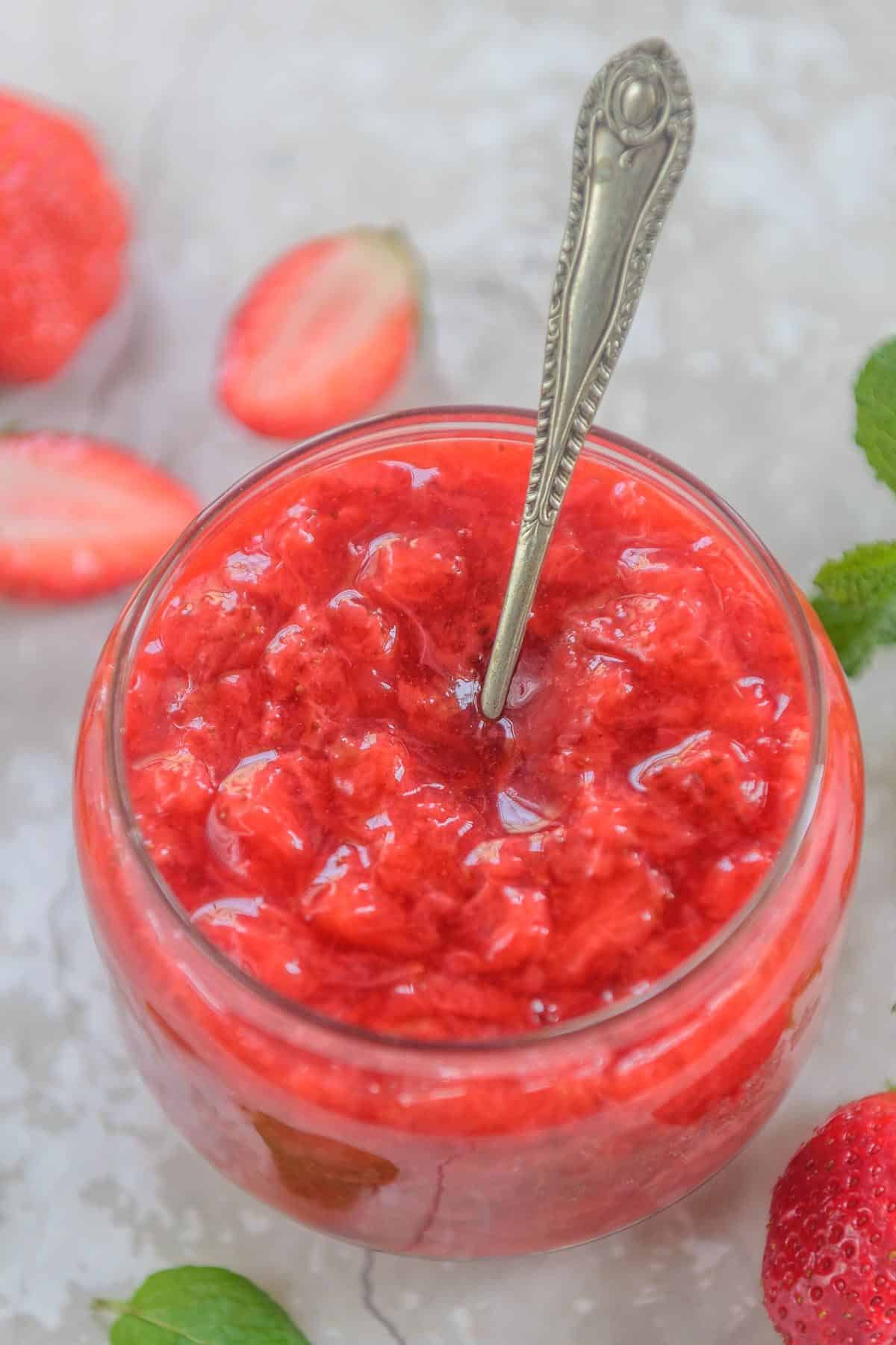 Strawberry sauce kept in a glass jar.