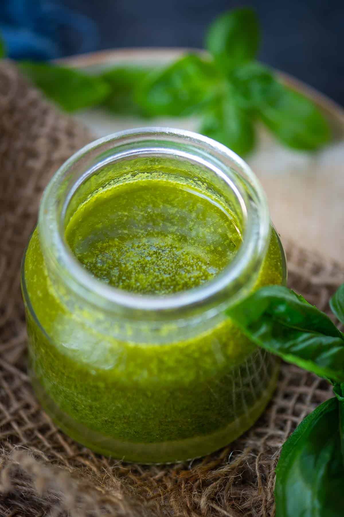 Lemon basil vinaigrette served in a glass bottle.