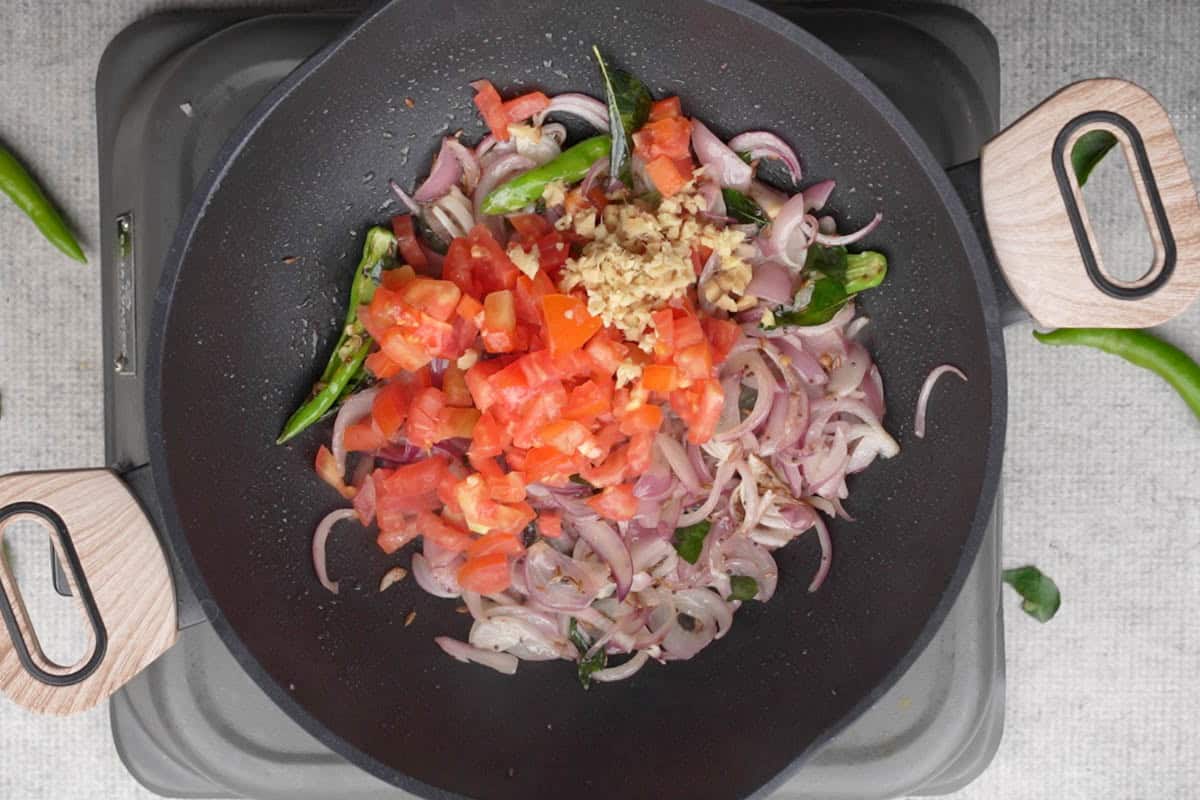 Tomatoes and ginger added to the pan.