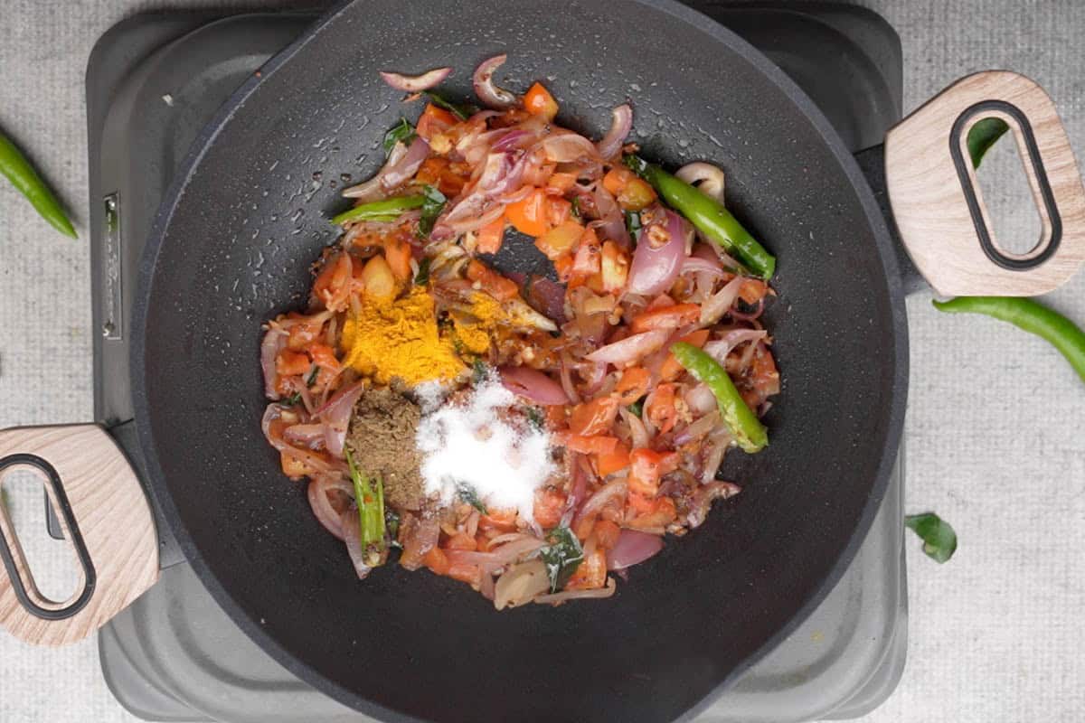 Spice powders added to the pan.