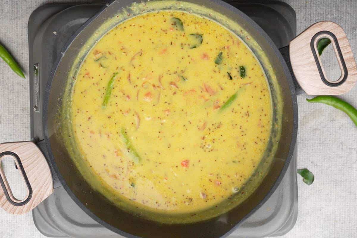 Besan slurry added to the pan.