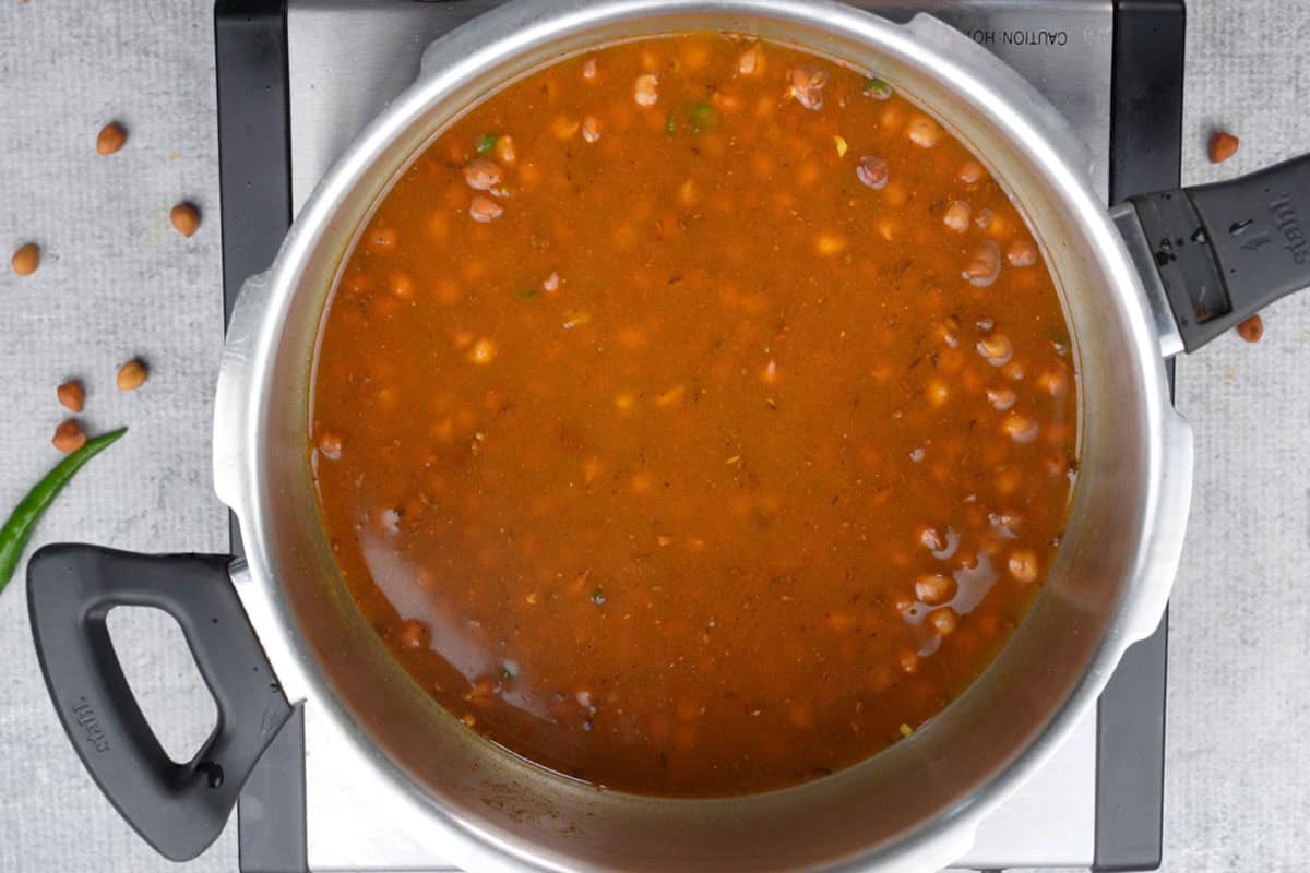 Chana and water added to the cooker.