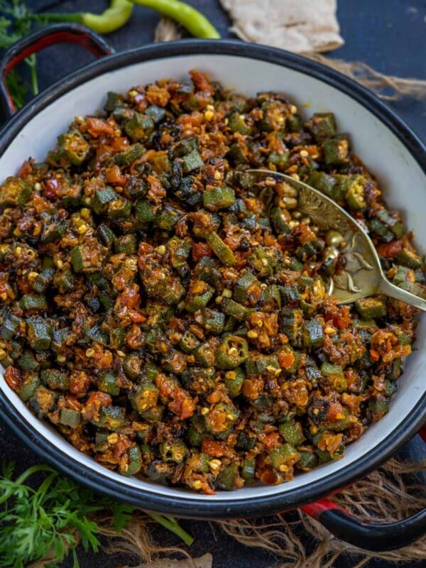 Dry Bhindi Masala (Indian Okra Stir Fry) is a very popular North Indian dish made using okra, onions, tomatoes, and spices. This sabji is super easy to make and comes together in under 30 minutes (vegan, gluten-free).