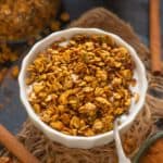 Make this healthy and super easy Pumpkin Spice Granola at home in under 30 minutes using 8 ingredients. It's super crunchy and loaded with fall flavors (vegan).