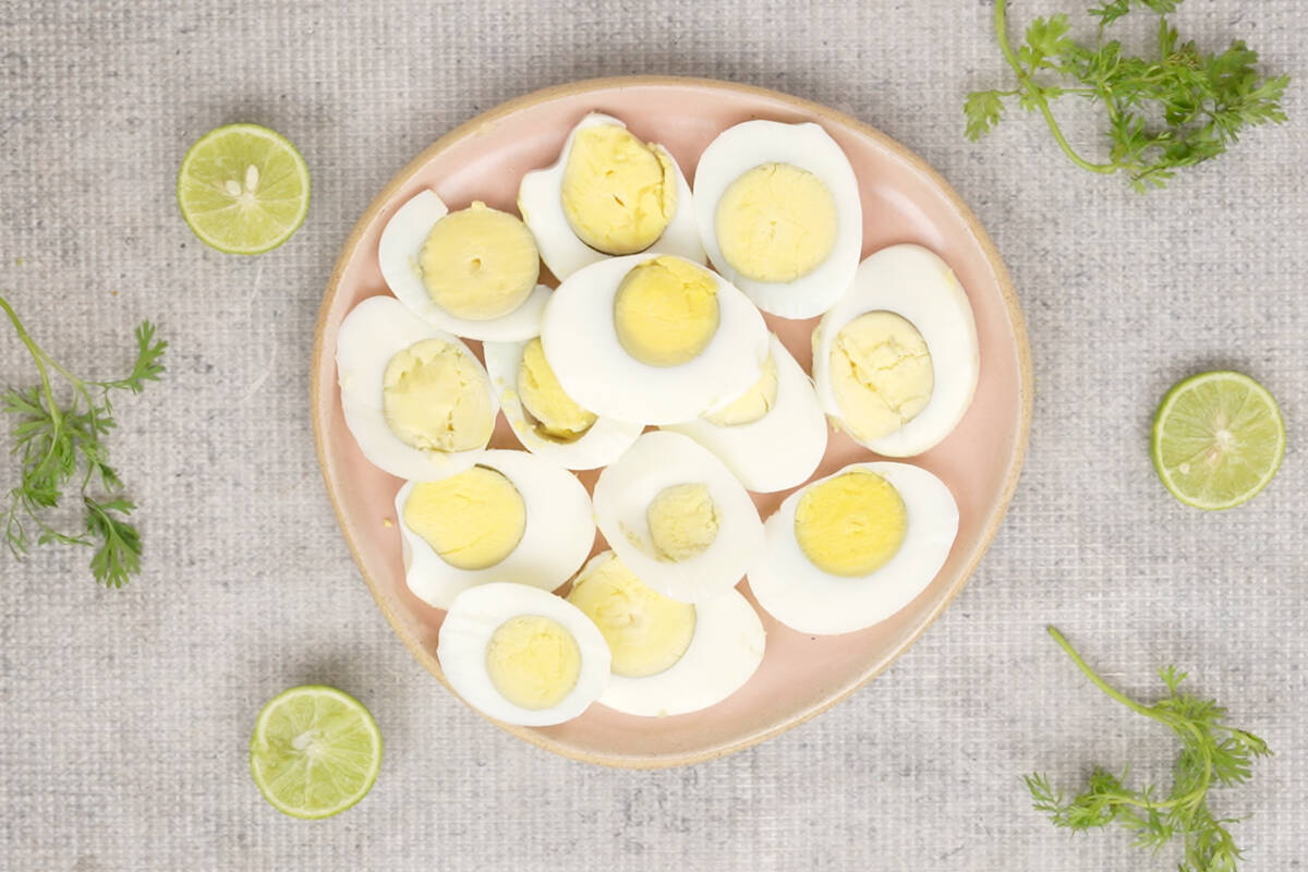 Sliced eggs arranged on a plate.