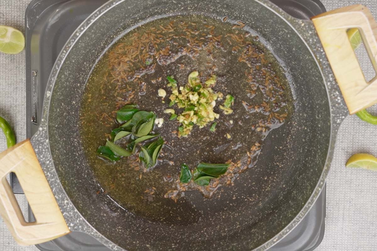 Ginger garlic chili paste and curry leaves added to the pan.