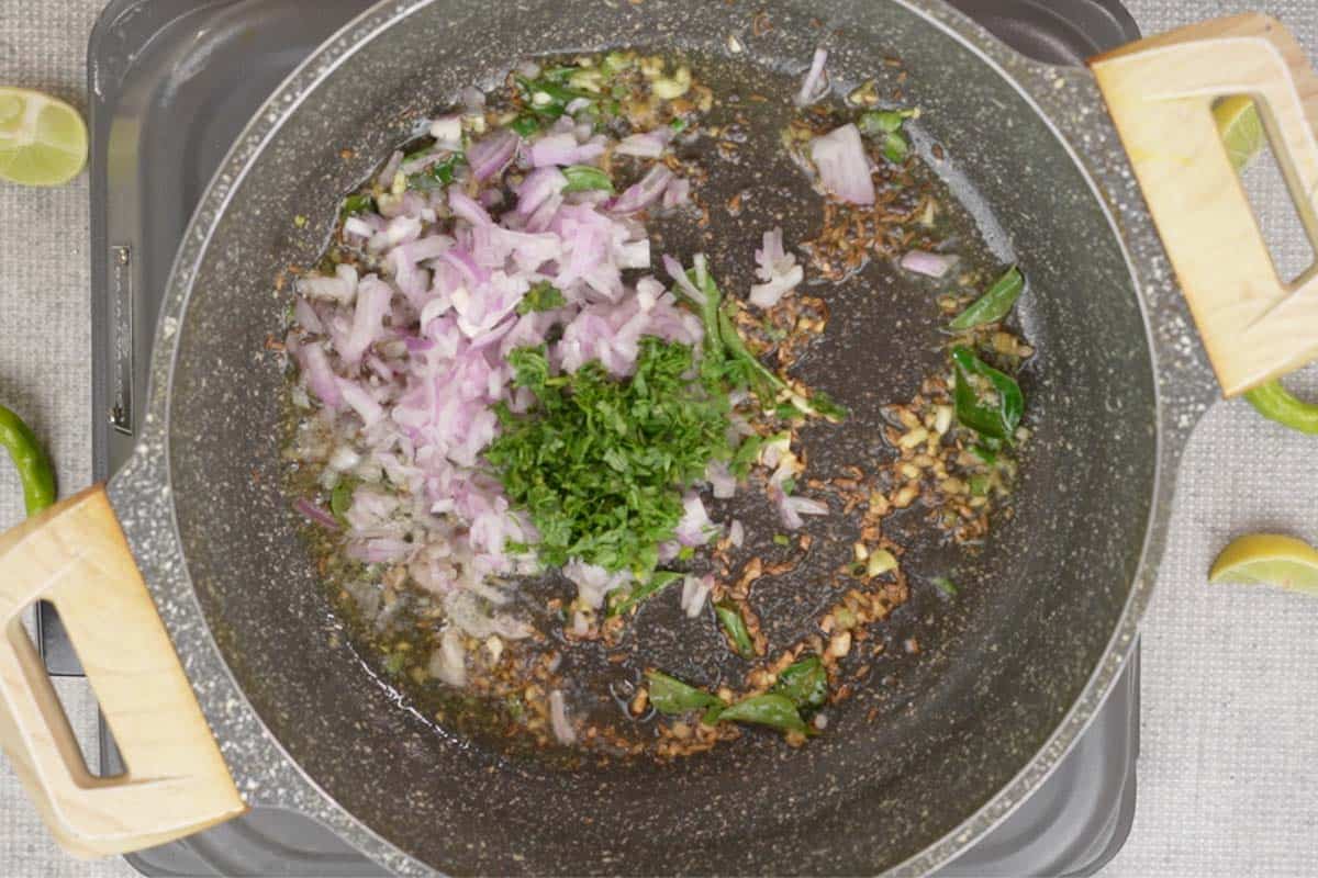 Onions and cilantro added to the pan.