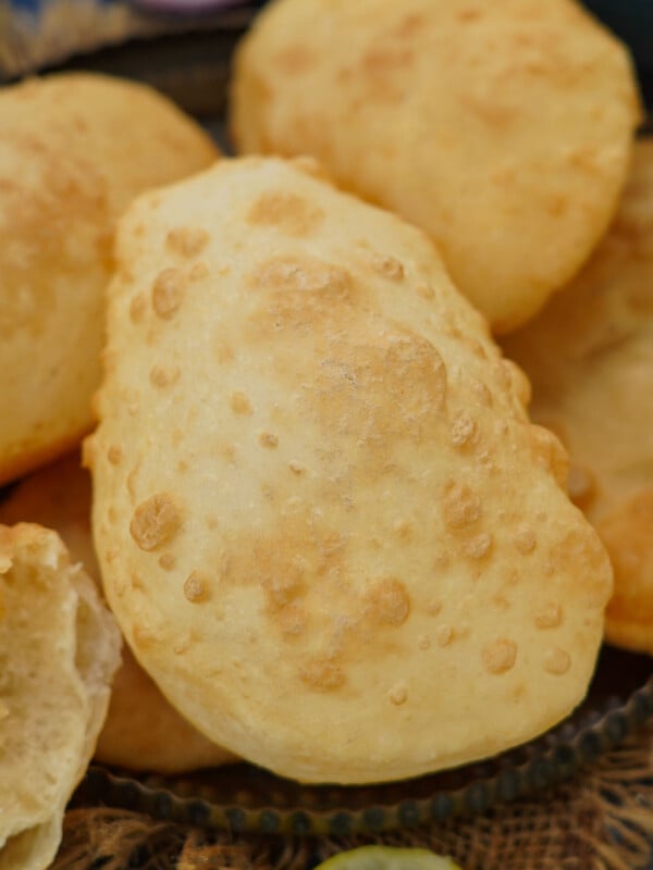 Bhatura is a fluffy, puffed, and deep-fried Indian bread (Punjabi) that is famously served with golden brown chickpea curry (chole) in India. Learn how to make Punjabi Bhatura at home using my easy, no yeast recipe.