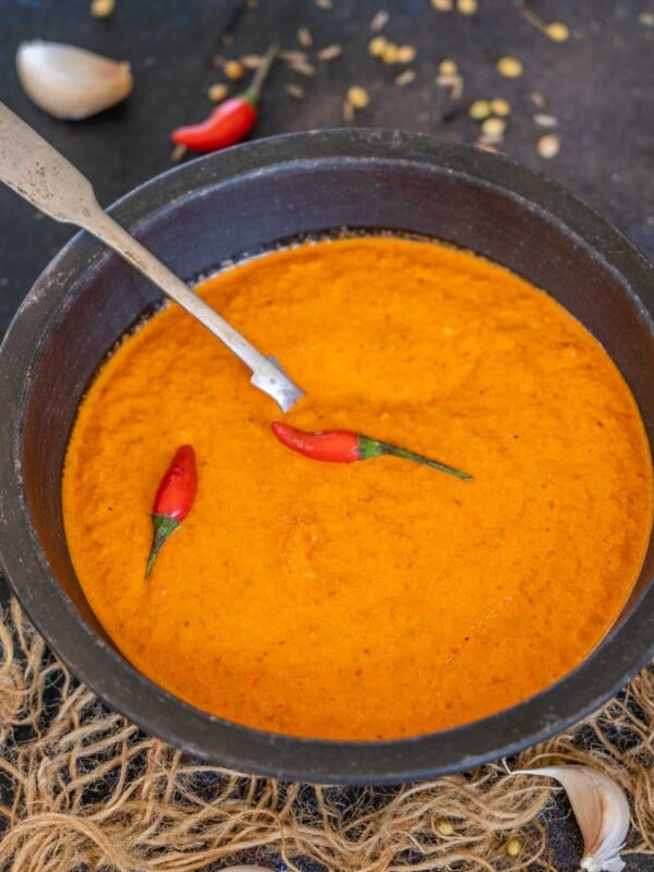 Make this North African & Middle Eastern Spicy Harissa Sauce at home using a few simple ingredients. It is vibrant red in color and adds smokiness and heat to whatever it is added to (vegan, gluten-free).