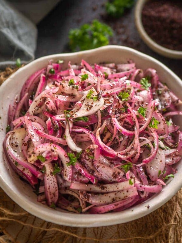 These 5-minute Sumac Onions are a Turkish-style onion salad or a pickle that adds a nice crunch to anything it's added to. Use this red onion salad in sandwiches, soups, or hamburgers to add a lovely flavor and a nice crunch to them (vegan, gluten-free).