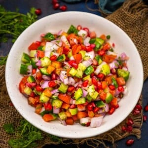 Made using freshly chopped veggies, Kachumber is a fresh, crunchy Indian onion cucumber tomato salad that doesn't need any cooking and can be rustled up whenever hunger strikes. Pair it with any Indian meal for a taste lift. It is vegan, gluten-free, and oil-free.