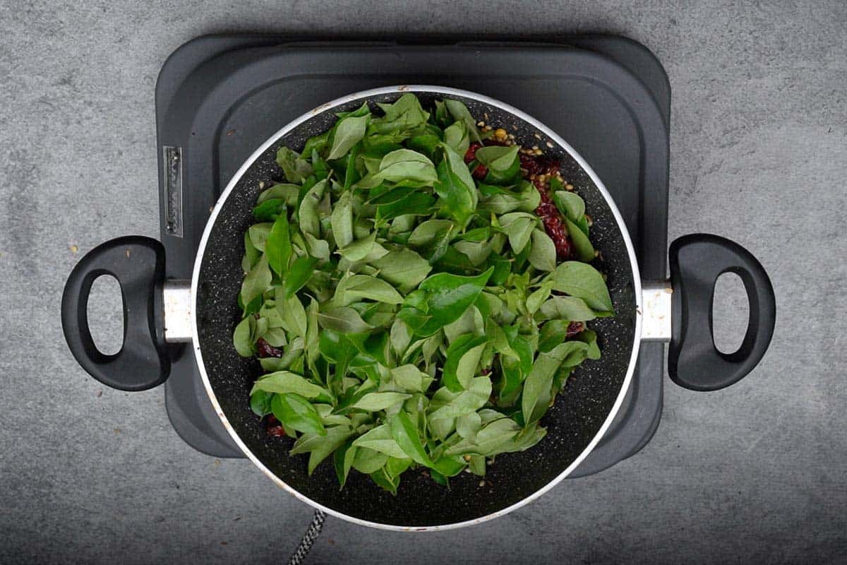 Curry leaves added to the pan.