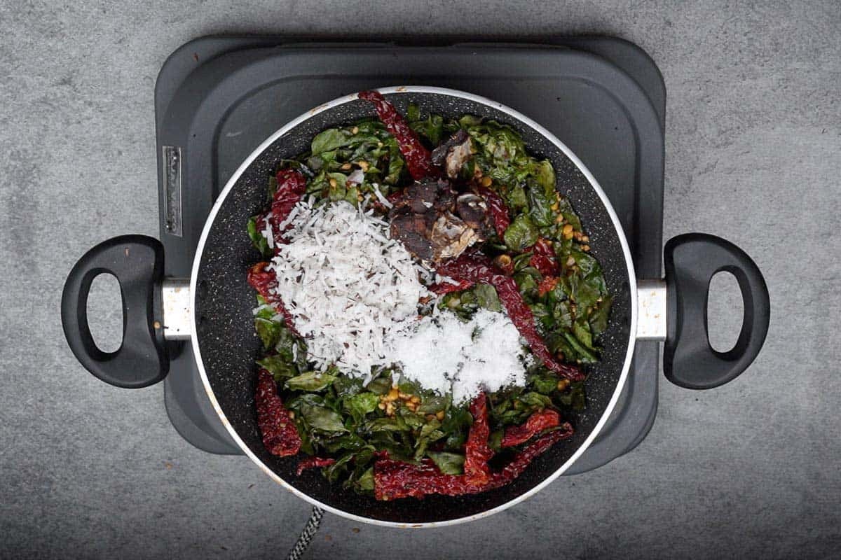 Tamarind, coconut and salt added to the pan.